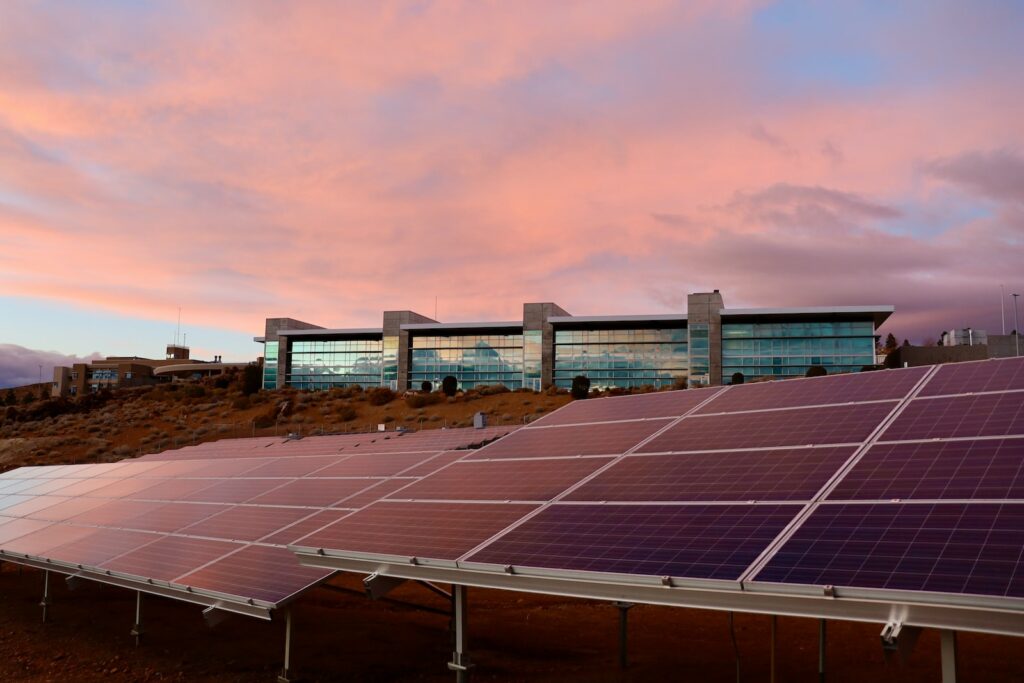 solar panels on brown field under white clouds during daytime