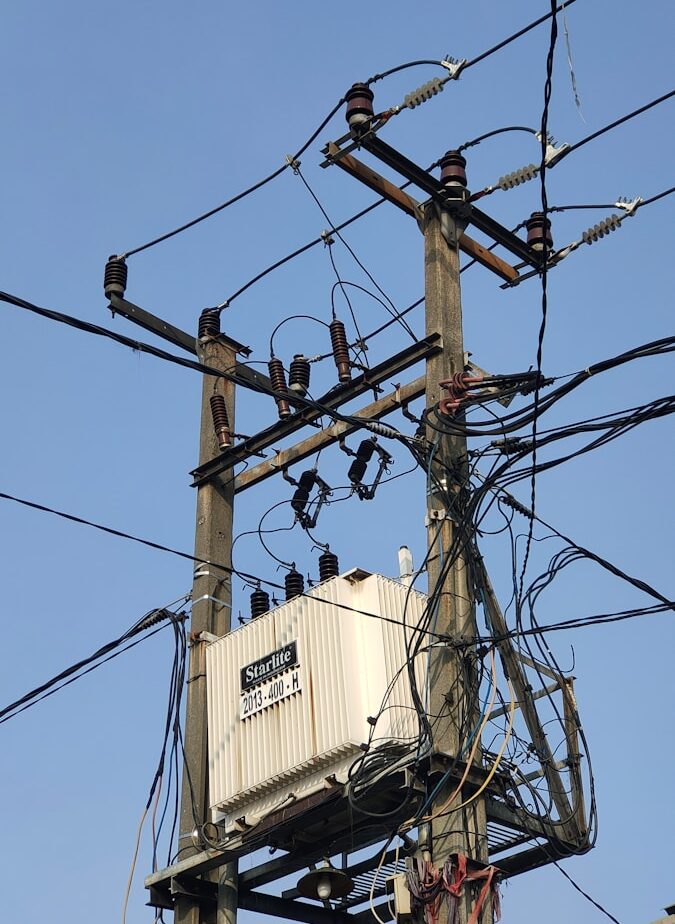 brown electric post with wires