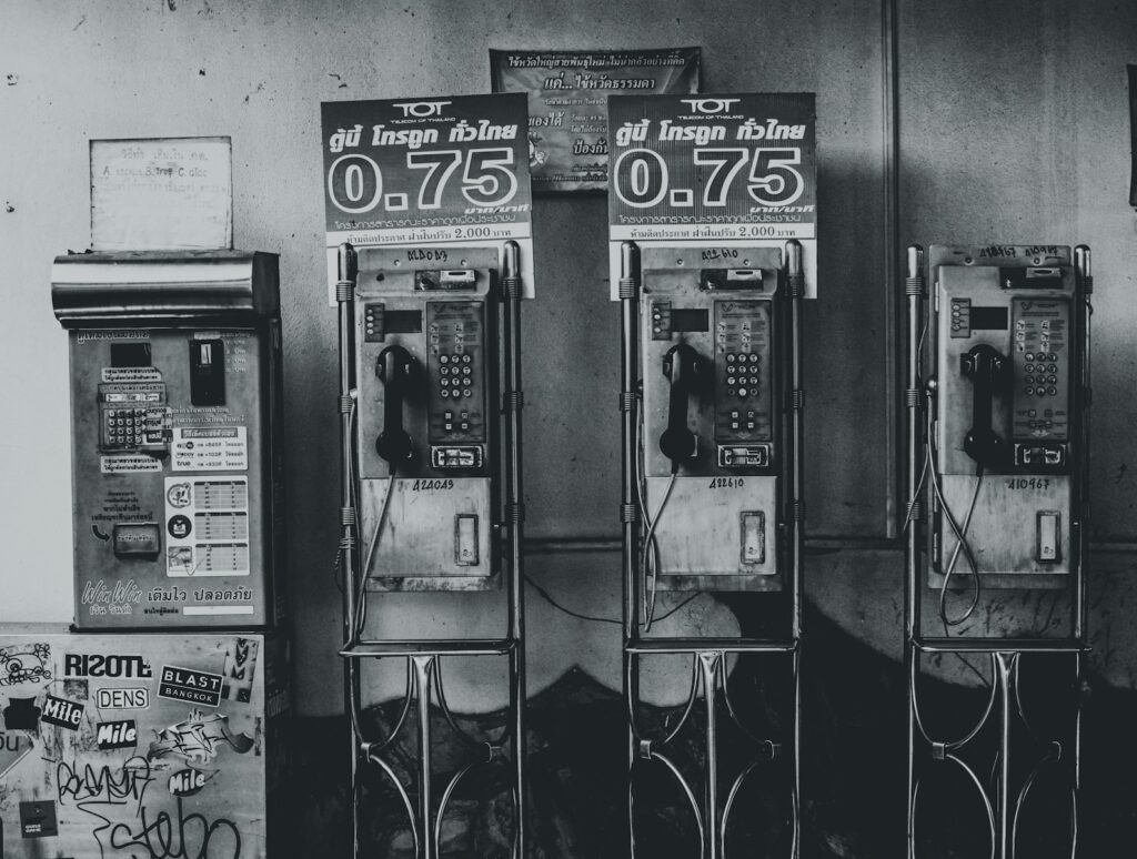 gray-scale photo of telephones